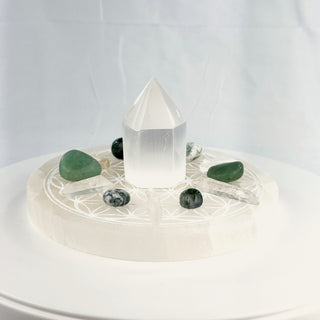 Crystal Grid Set for Abundance, side view, selenite tower centered on the Flower of Life plate with tree agate, moss agate, green aventurine and Lemurian quartz points